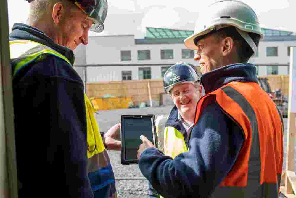Image of MJConroy construction workers using HammerTech on the job site for construction safety.